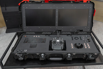 Portable ground control station in heavy-duty case with dual screens, radio transmitter, joystick, and keyboard for UAV drones © Viktor Brazhnikow