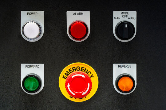 Industrial control panel with red emergency stop button, power indicator, mode switch, forward and reverse push buttons