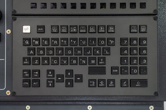 Close-up of industrial CNC machine control panel keyboard with QWERTY layout, function keys, and numeric keypad