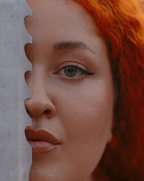 Redhead Warrior Woman Holding Sword Blade Near Face