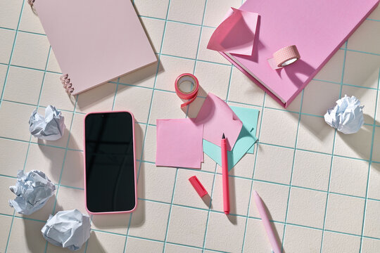 A collection of pink stationery and a smartphone