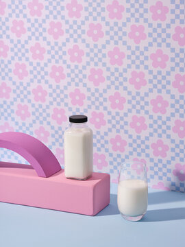Aesthetic arrangement of a glass and a bottle filled with milk