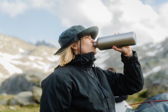 A female hiker drinking water