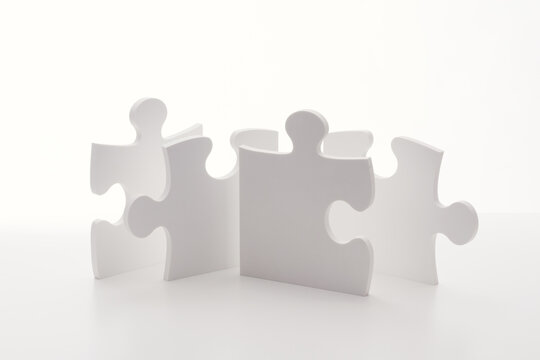 Interconnected Puzzle Pieces in Circle Representing Teamwork and Collaboration
