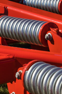 Steel silver spring as part of heavy agricultural, industrial machine. Technology