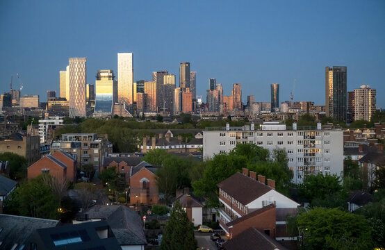 Canary Wharf Towers Shining Over London Homes During Blue Hour