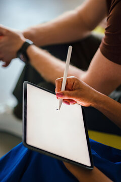 Hands Using Stylus On Tablet