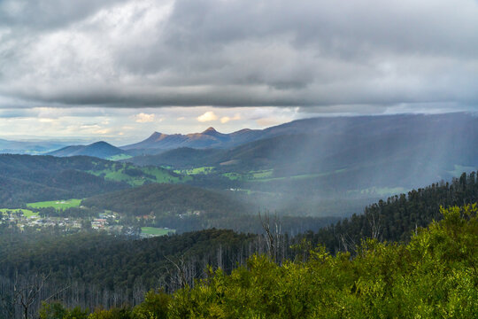 An afternoon rain shower falling over a mountain valley