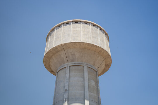 Concrete Water Tower Against Clear Blue Sky