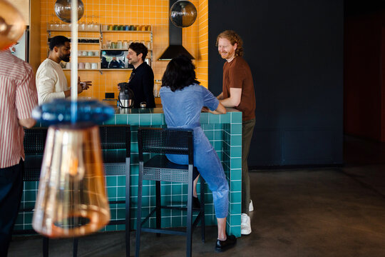 Friends Talking at Modern Tiled Cafe Counter