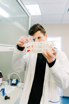 A man holds test tubes in a laboratory.