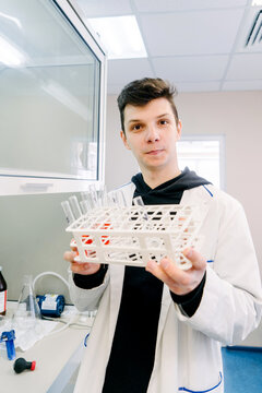 A chemist holds test tubes in his hands.