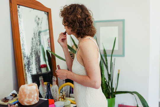 woman doing makeup at home
