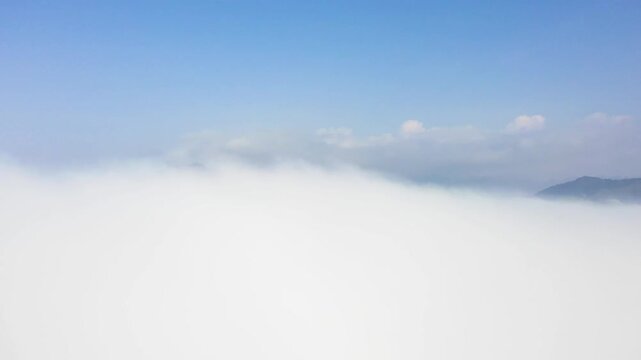 Aerial view of a cloud inversion covering the mountain peaks in Cao Bang, northern Vietnam. The scene highlights the dramatic natural beauty and tranquil atmosphere of the Cao Bang region.