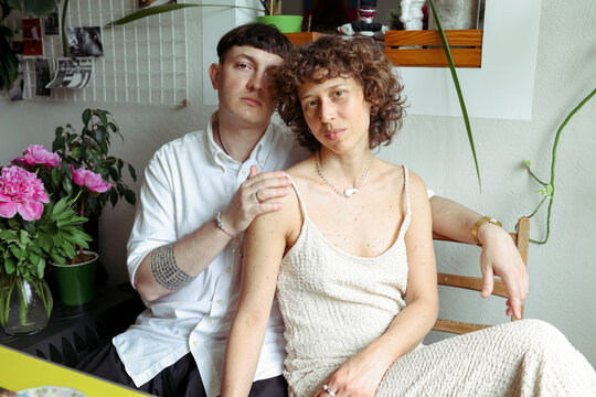 A couple is spending time in the kitchen.