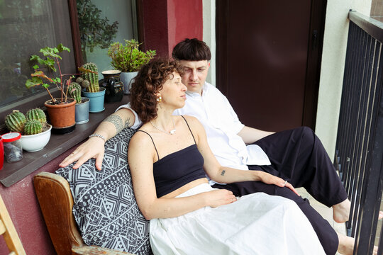 A couple is spending time on the balcony
