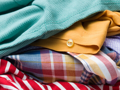 Macro Close-Up of Stacked Colorful Fabrics and Clothes