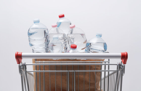 Shopping Cart Filled with Plastic Water Bottles for Daily Supply