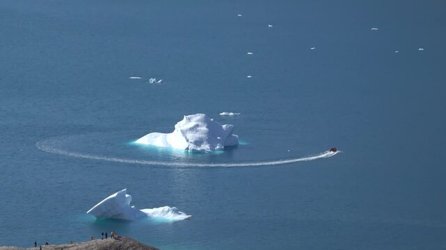 Zodiac Cruising Past Massive Iceberg Near Disko Bay
Zodiac boat cruises past massive iceberg near Disko Bay, Western Greenland, 26 August 2026.
