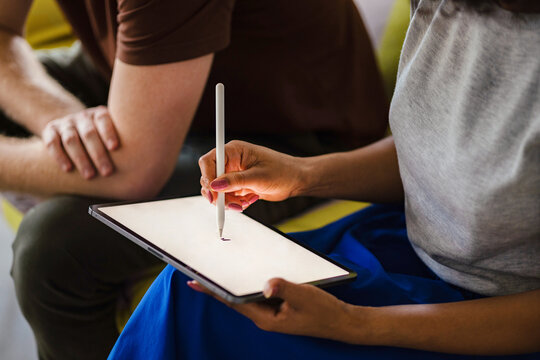 Two Colleagues Collaborating on a Tablet With Stylus