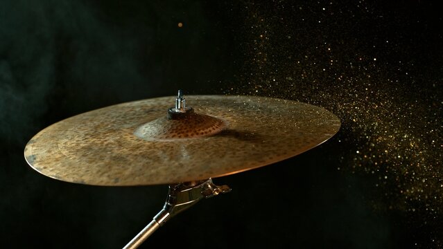 Golden Glitter Explosion From Cymbal on Black Background