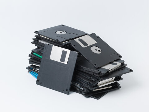 Messy Pile of Old Floppy Disks Isolated on White Background