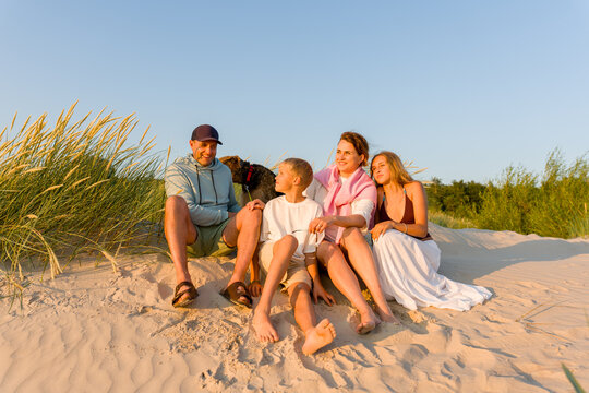 Family Enjoys Time on Sandy Beach at Summer