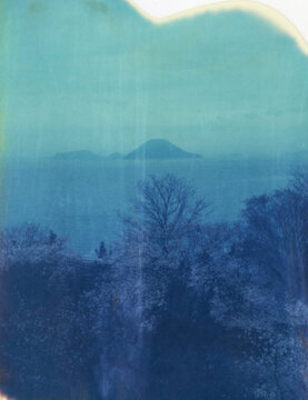 A view of cherry blossoms, mountains, and the sea in Japan
