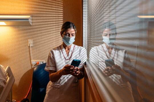 Medical professionals caring for elderly patient in hospital room