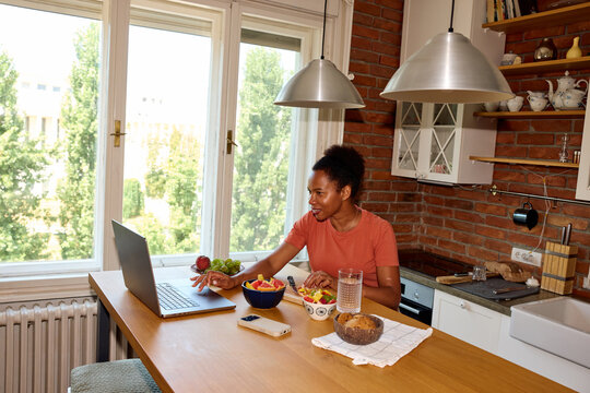 Woman works from home, checking her computer