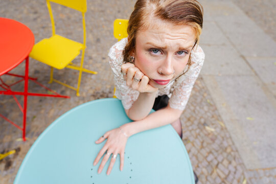Woman Waiting Alone at Cafe Table