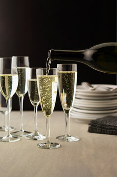 Champagne being poured into glasses during a gathering