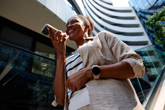 Woman sends voice messages via her phone in the city