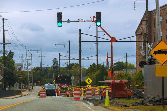 Traffic signals are with green light as workers manage road reconstruction on city street