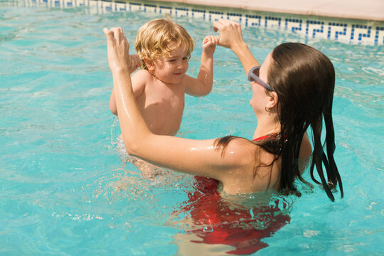 Mother and child play together in the swimming pool