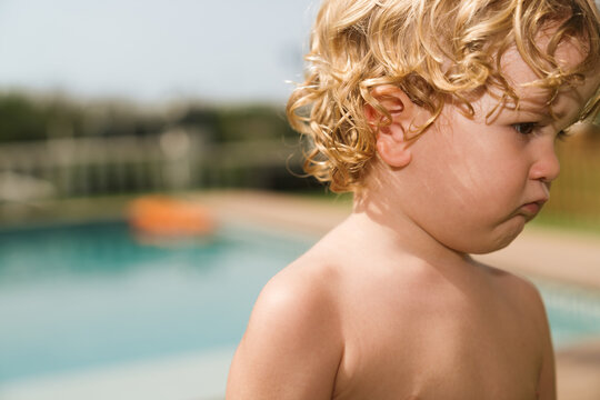 Child at poolside during sunny day