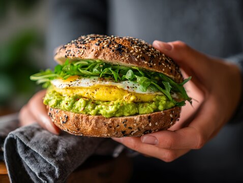 Hand holding a freshly made breakfast sandwich