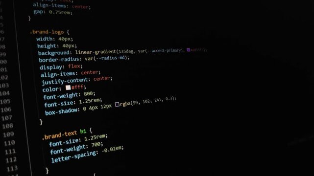 Computer source code scrolling on a dark screen editor
