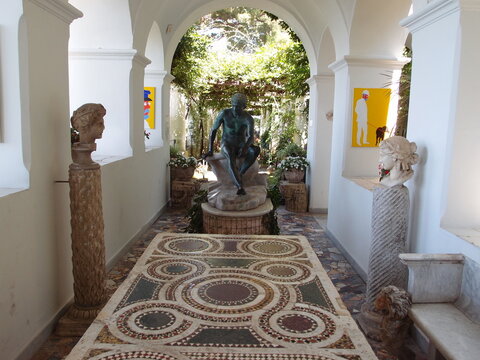 Vaulted loggia gallery filled with ancient marble statues