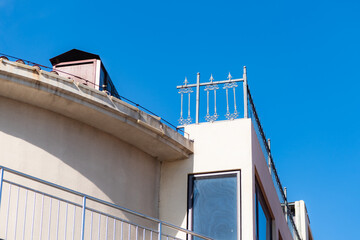 Low‑angle partial close‑up of iron railings on building roof © Xiangli