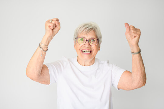 Portrait of elderly woman with eyeglasses over studio white