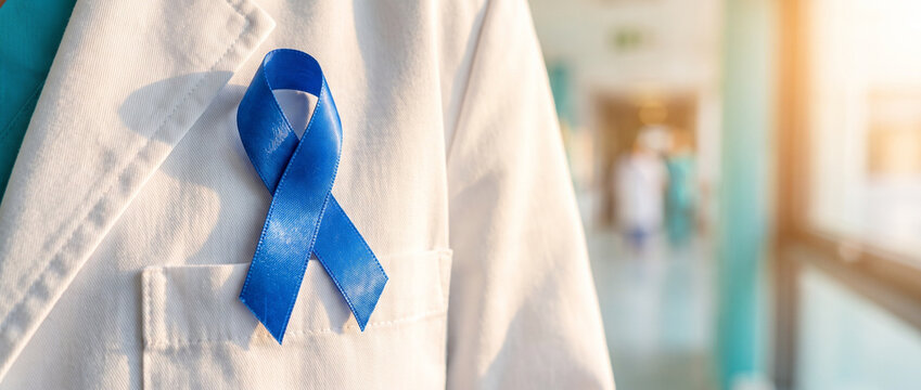 Blue ribbon on medical coat symbolizing support for health awareness and professional excellence. This image is relevant for medical staff during International Day of Radiology.