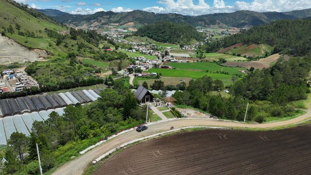 Aerial view of the Portezuelo chapel nestled in the lush green mountains of Constanza, La Vega, Dominican Republic.