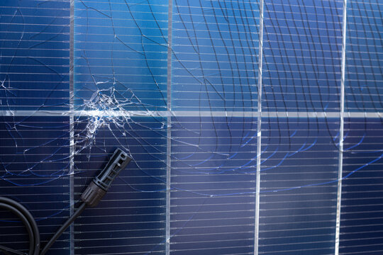 Damaged Solar Panel with Cracked Surface and Electrical Connector