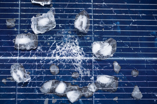 Hail-Damaged Solar Panel with Ice and Shattered Glass