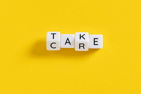 take care message spelled on white blocks on yellow background