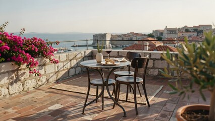 Naklejka premium Romantic seaside balcony with table and chairs overlooking sunset and harbor view