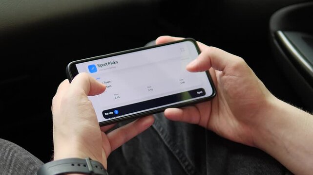 User browses live football odds on a smartphone, reflecting the rapid growth of mobile sports betting, real-time markets and digital fan engagement.