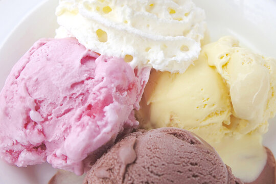 Fresh ice cream vanilla, strawberry and chocolate with whipped cream