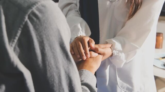 Woman, doctor and holding hands with patient for consultation, sympathy or comfort at hospital. Closeup, female person or medical professional with touch for grief, news or empathy at clinic visit